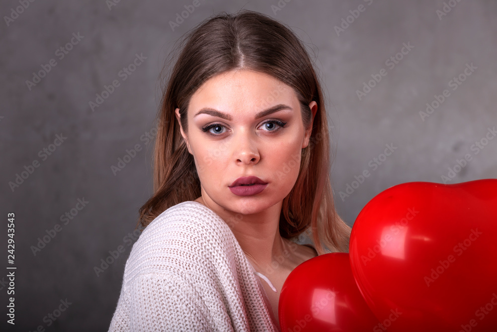 Young beautiful girl with red balloons in heart shape Young beautiful girl with red balloons in heart shape