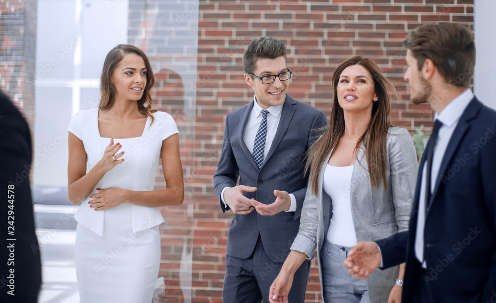 business team talking standing in the office corridor business team talking standing in the office corridor