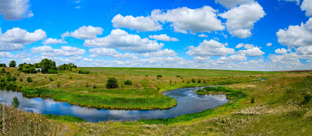 Sunny summer panorama with river curve.
