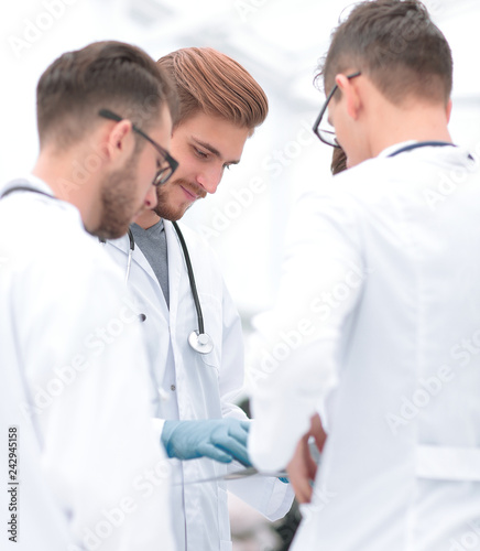 smiling doctors discussing x-ray with colleagues