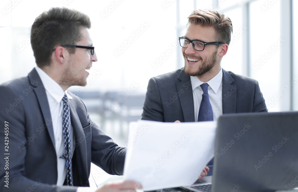 business partners discussing business document. business partners discussing business document.