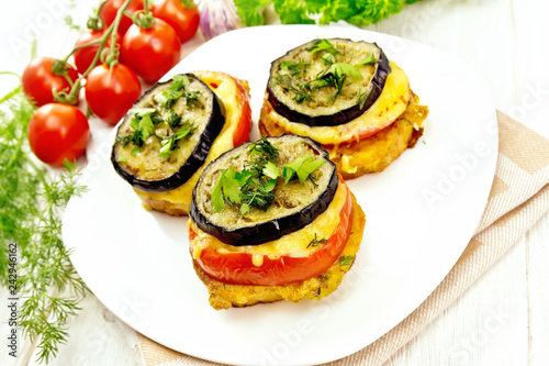 Appetizer of aubergines and cheese in plate on light board