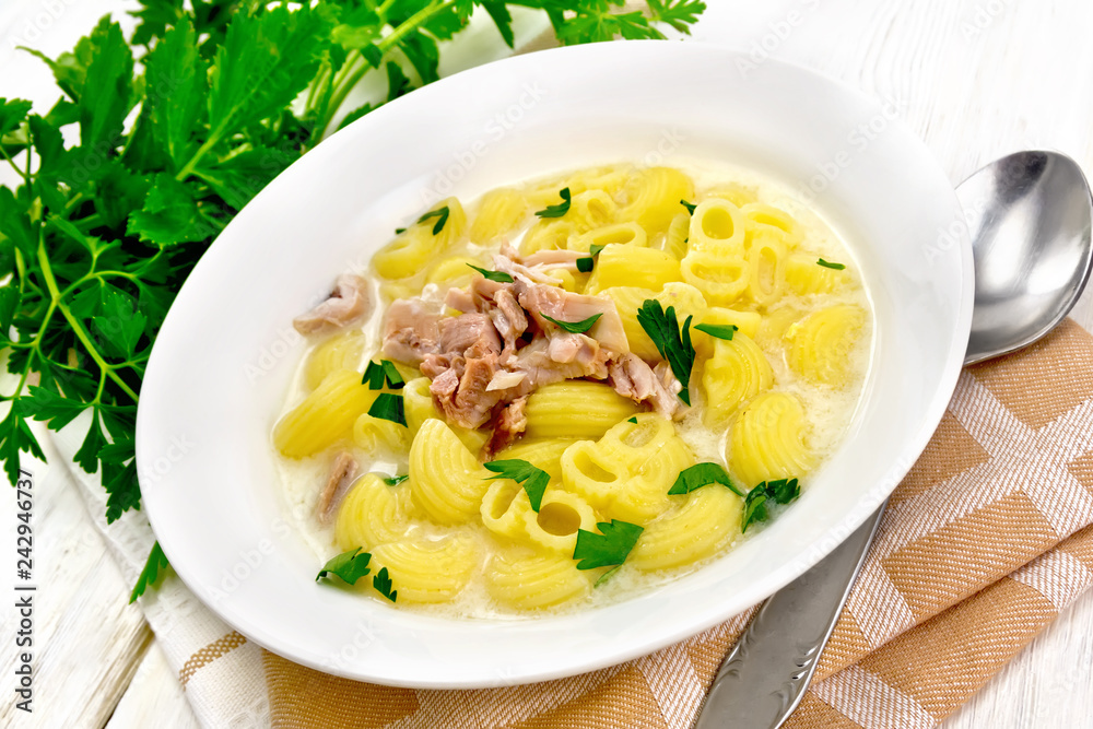 Soup creamy of chicken and pasta in plate on kitchen towel