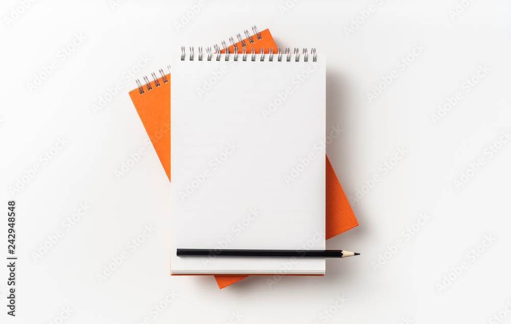 Top view of orange spiral notebook, page, pencil Top view of orange spiral notebook, page, pencil