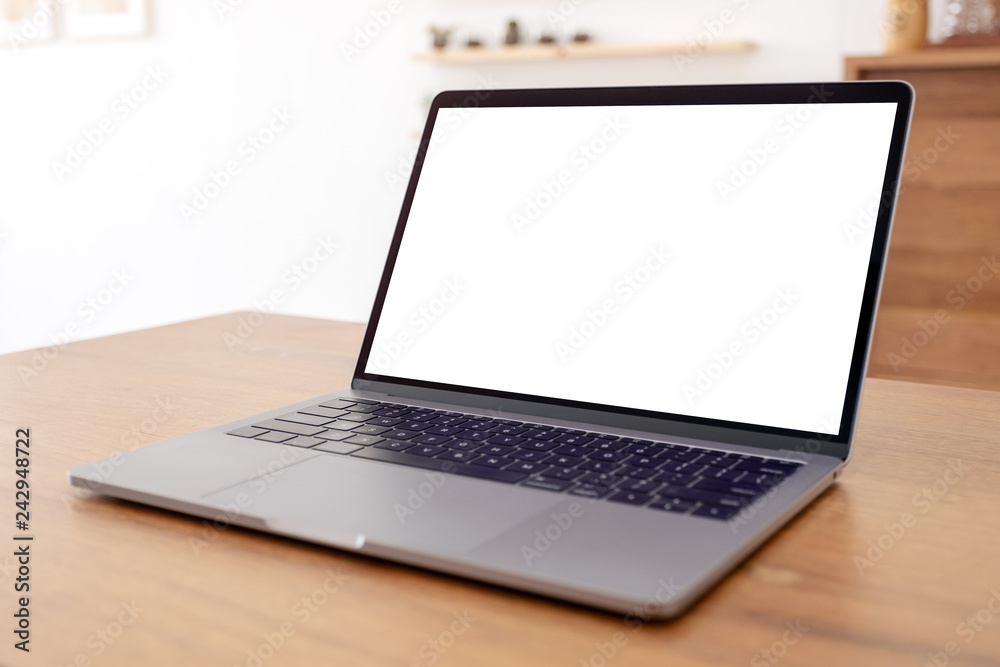 Mockup image of laptop with blank white desktop screen on wooden table