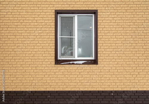 Window in a new brick house as a background