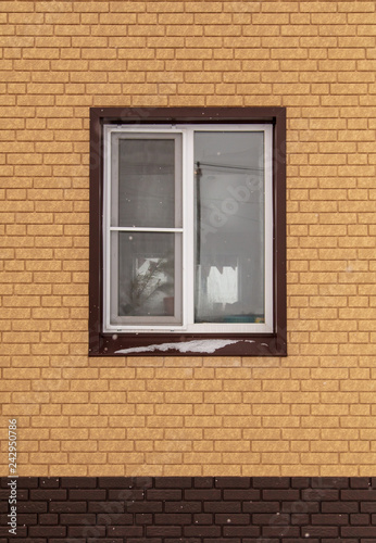 Window in a new brick house as a background