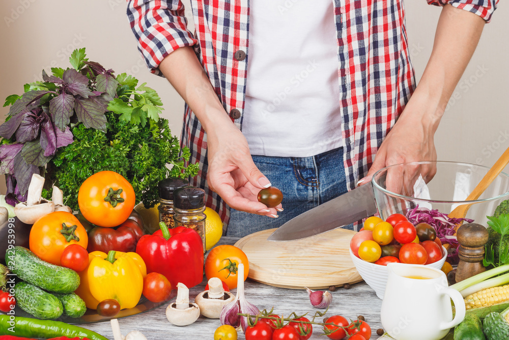 Woman cooks at the kitchen, body part, blurred background