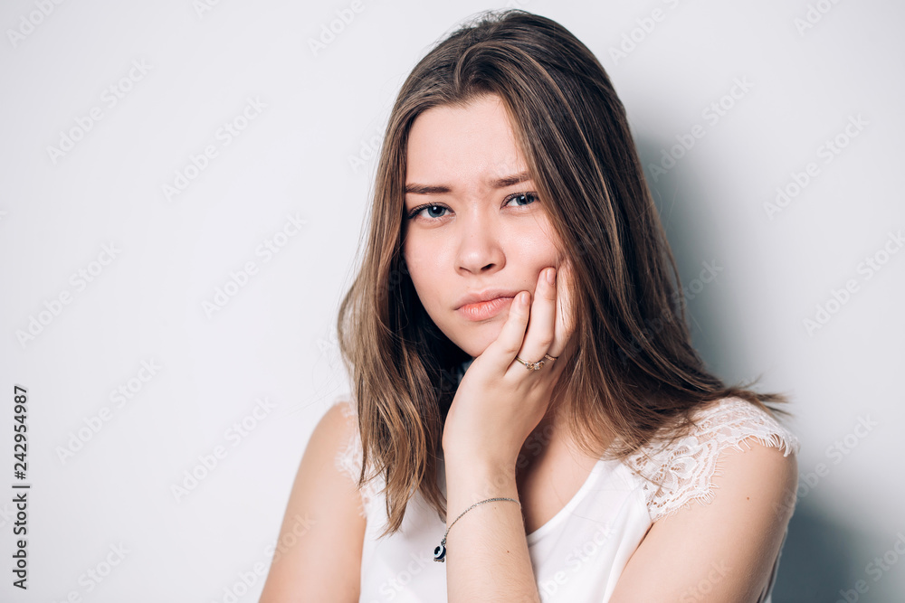 Beautiful sad unhappy woman feel pain on her teeth isolated on white background Beautiful sad unhappy woman feel pain on her teeth isolated on white background