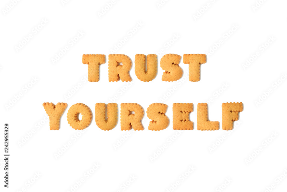 Top view of the word TRUST YOURSELF spelled with alphabet shaped biscuits isolated on white background Top view of the word TRUST YOURSELF spelled with alphabet shaped biscuits isolated on white background