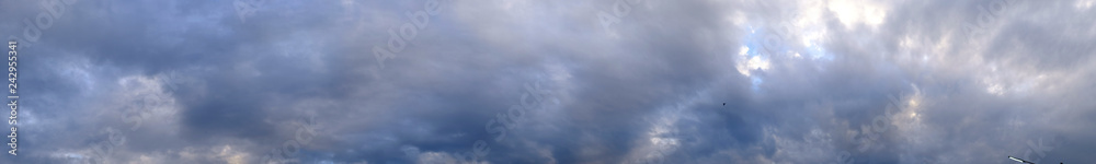 Fototapeta premium Panorama evening sky with blue, white and gray clouds.