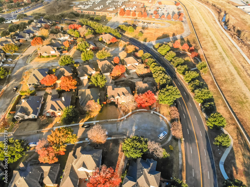 Aerial view parkside neighborhood with cul-de-sac (dead-end) street near Dallas, Texas. Flyover urban sprawl in autumn morning with colorful fall foliage leaves photo