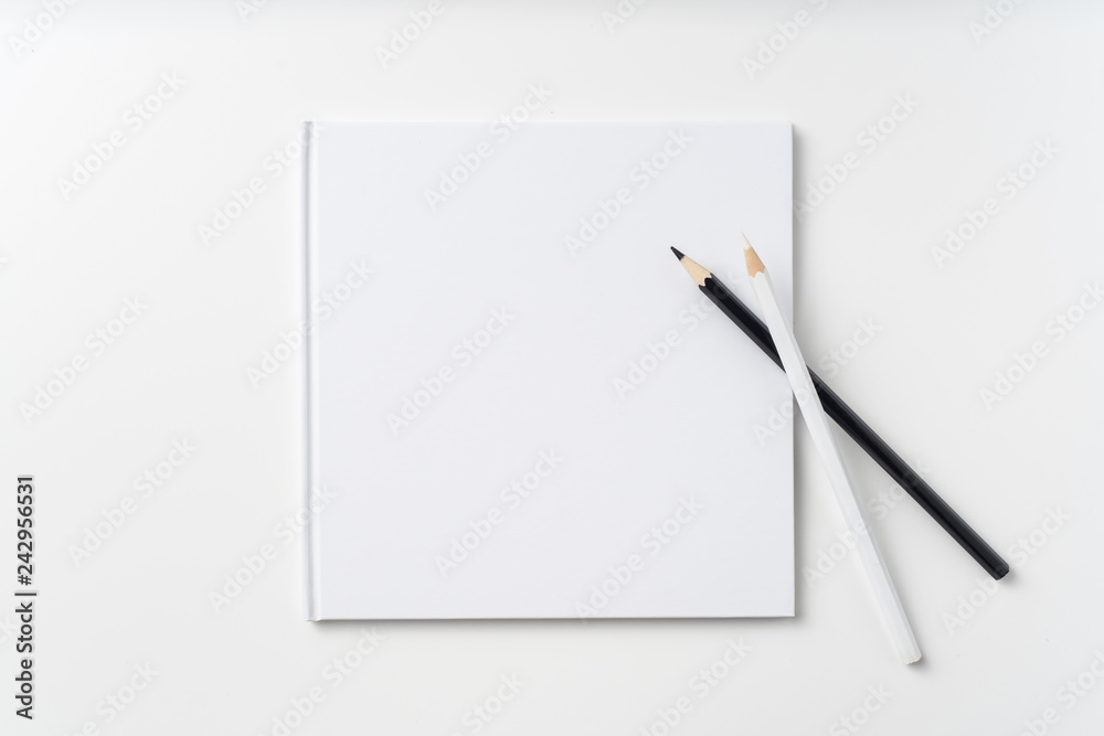 Top view of white notebook, page, pencil Top view of white notebook, page, pencil
