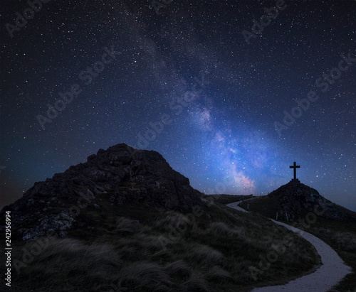 Vibrant Milky Way composite image over landscape of Ynys Llanddwyn Island with Twr Mawr lighthouse in background