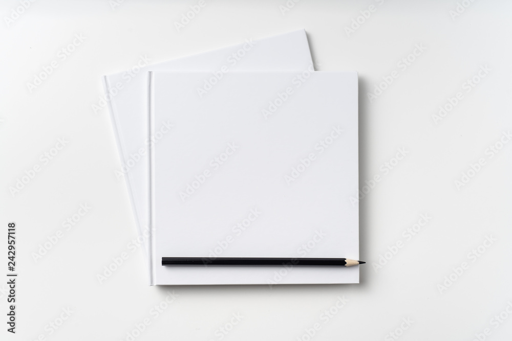 Top view of 2 white hardcover notebook, pencil Top view of 2 white hardcover notebook, pencil