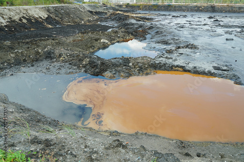 Contamination soil and water spot oil pollutions, former dump toxic waste, effects nature from contaminated soil and water with chemicals, environmental disaster environment, oil lagoon