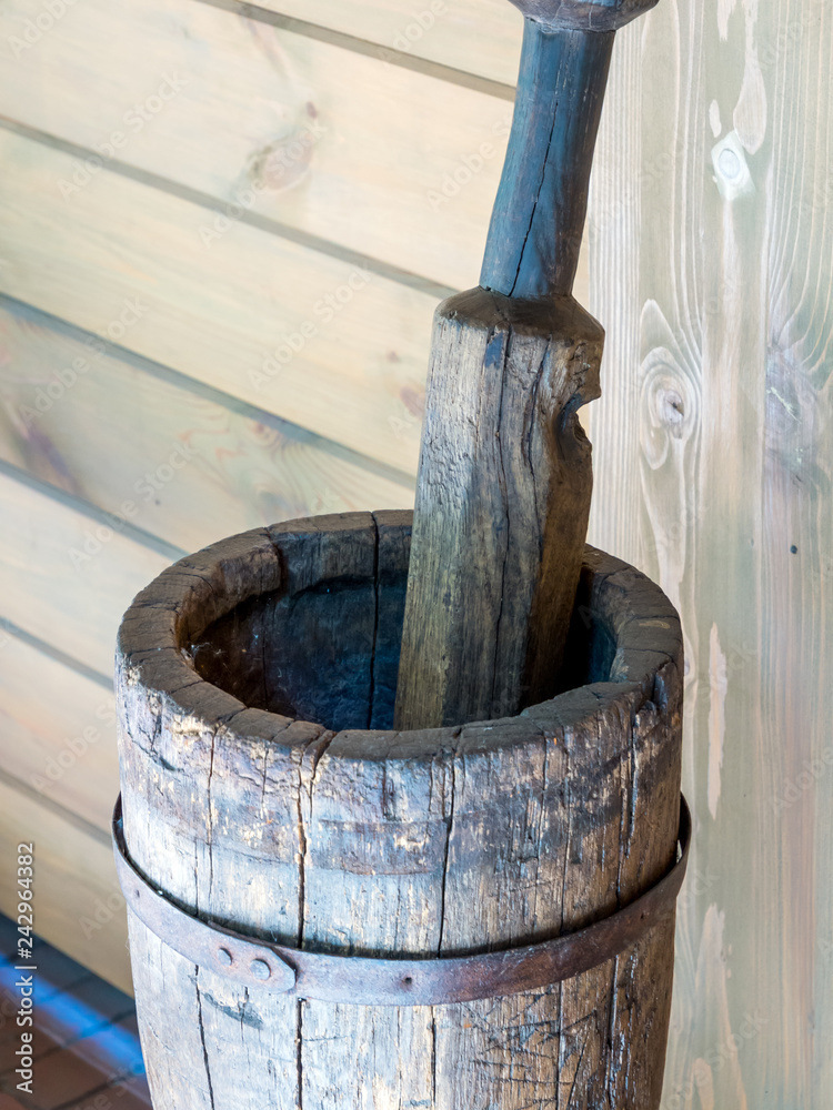 An old wooden stupa with a wooden pestle in it An old wooden stupa with a wooden pestle in it