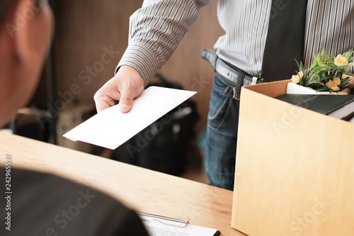 Cuadro en lienzo Business man sending resignation letter to boss and Holding Stuff Resign Depress or carrying cardboard box by desk in office