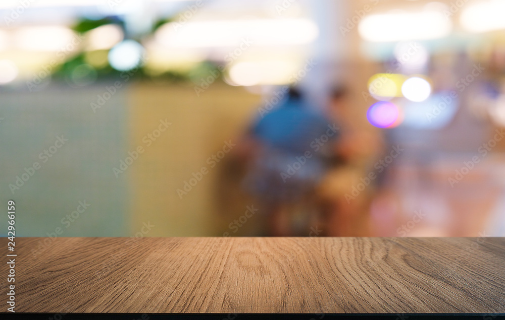 Empty dark wooden table in front of abstract blurred bokeh background of restaurant . can be used for display or montage your products.Mock up for space.