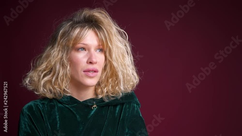 Closeup portrait of young attractive caucasian female with blond hair looking on the side front view