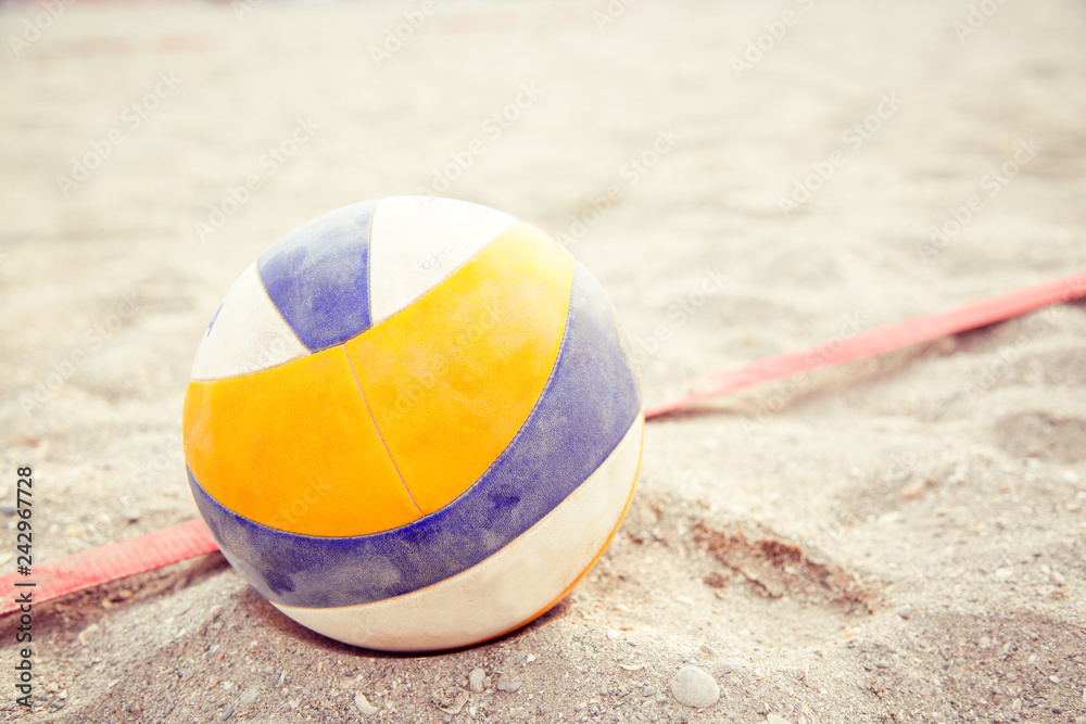 Beach Volleyball. Game ball under sunlight and blue sky. Volleyball in the sand at the beach