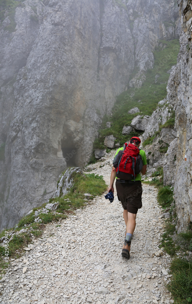 hiker walks on a steep mountain trail