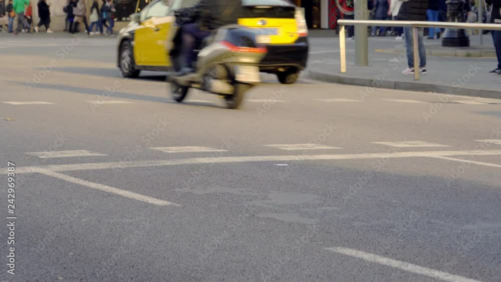 Zoom view of a rush hour in Barcelona street with the yellow and black characteristic taxis of the city passingby Zoom view of a rush hour in Barcelona street with the yellow and black characteristic taxis of the city passingby