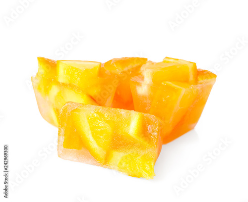Ice cubes with orange slices on white background