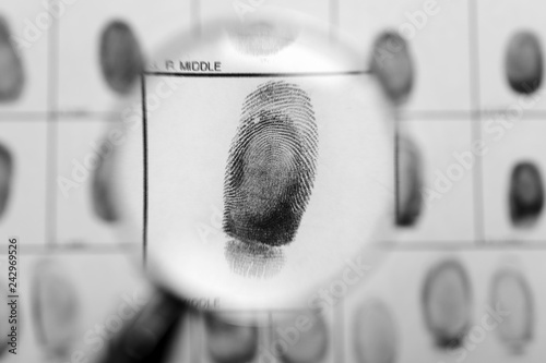 Criminal fingerprint card and magnifier, top view