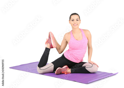 Young beautiful woman stretching on white background. Home fitness