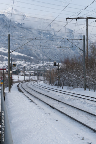 train tracks in the Swiss countryside covered in snow in deep winter