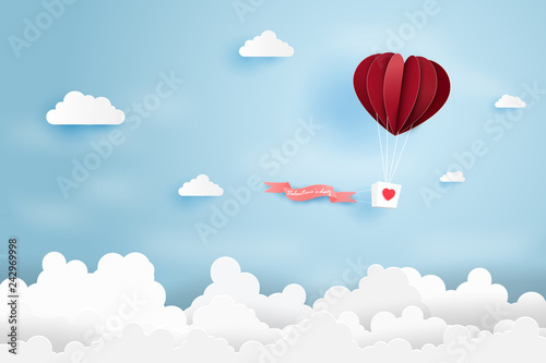 Heart air balloon made origami float over blue sky,Paper art style.