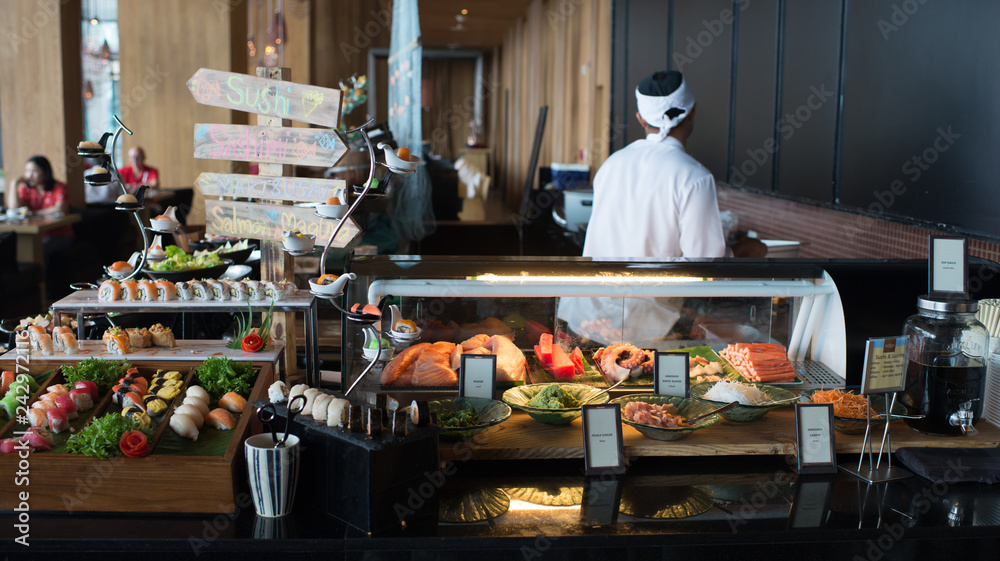 chef in the kitchen Japanese sushi bar buffet in hotel Stock Photo | Adobe  Stock