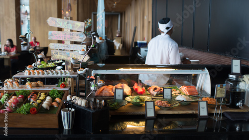 chef in the kitchen Japanese sushi bar buffet in hotel