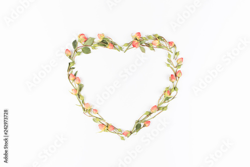 Heart of pink roses on white background. Flat lay, top view. Floral background. Valentine's background.