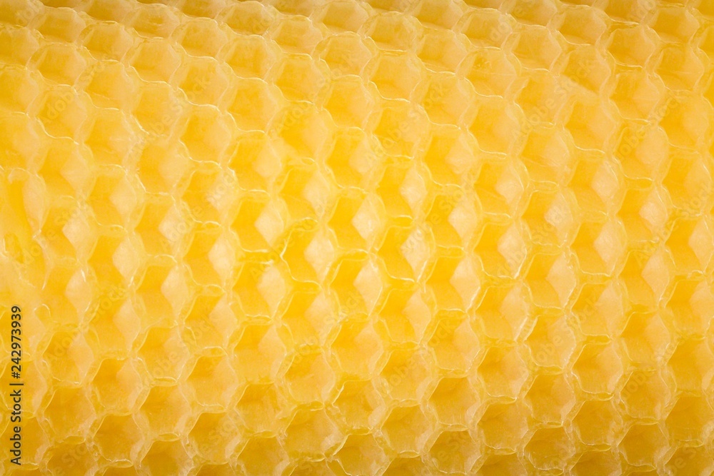 Natural handmade beeswax candle. Close up. Honey comb pattern