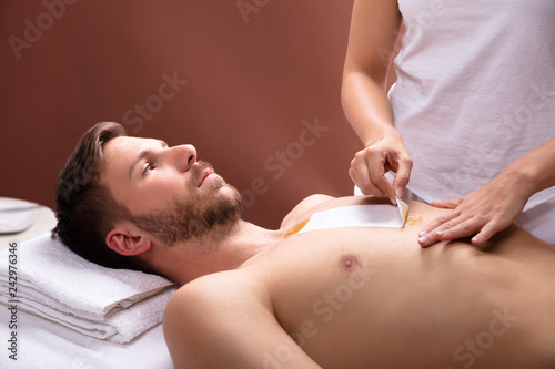 Therapist Waxing Man's Chest
