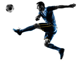 one caucasian soccer player man playing kicking in silhouette isolated on white background