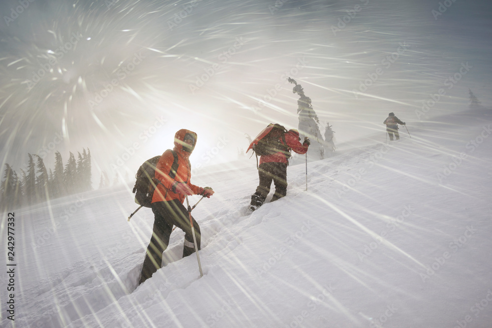 climbers in mountain snowfall