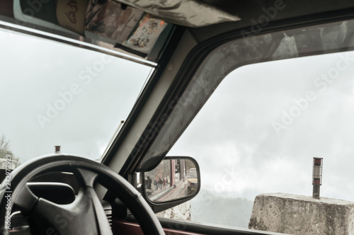 Side rear-view mirror on a car on a countryside road.Selective focus