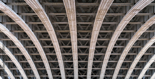 Framework arch under a bridge over the river Thames in London.