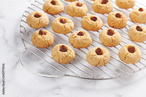 Fresh baked almond cookies on stainless steel grille