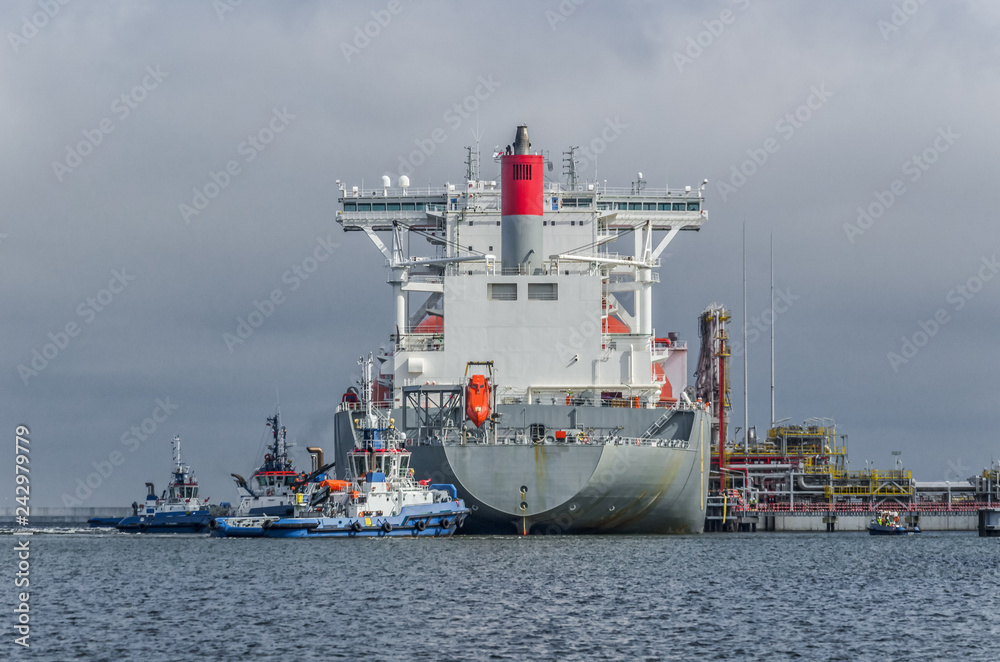 LNG TANKER - Ship and tugs are maneuvering at the gas terminal in Swinoujscie