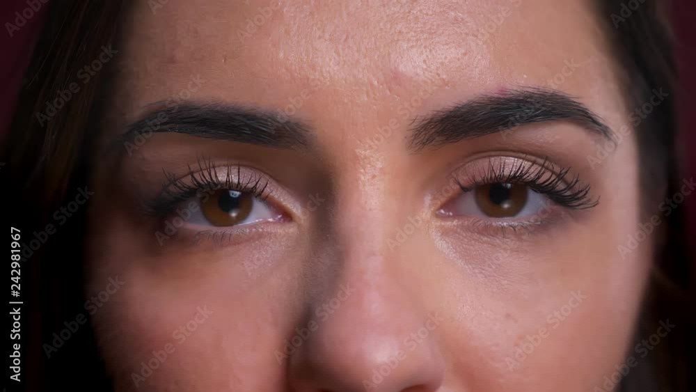 Closeup portrait of beautiful caucasian female brown eyes looking straight at camera with neutral facial expression