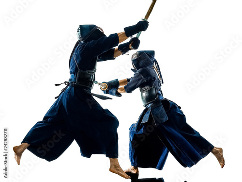two Kendo martial arts fighters combat fighting in silhouette isolated on white bacground