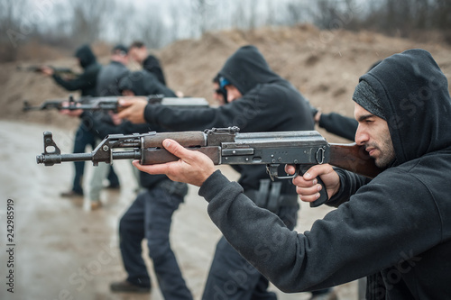 Large team action training with rifle machine gun. Shooting range © guruXOX