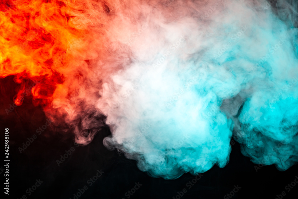 Translucent, thick smoke, illuminated by light against a dark background, divided into two colors: blue and red, burns out, evaporating from a pair of vape.