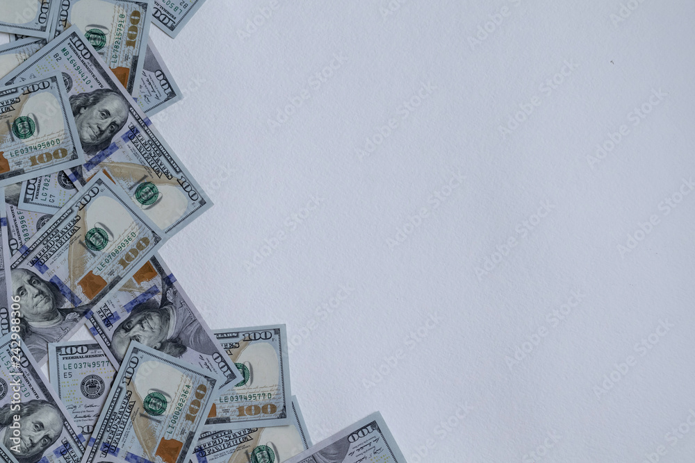 One hundred new US dollar banknotes, selective focus effect. One hundred dollars background. Concept finance, investments, deposits. Free red space for text.