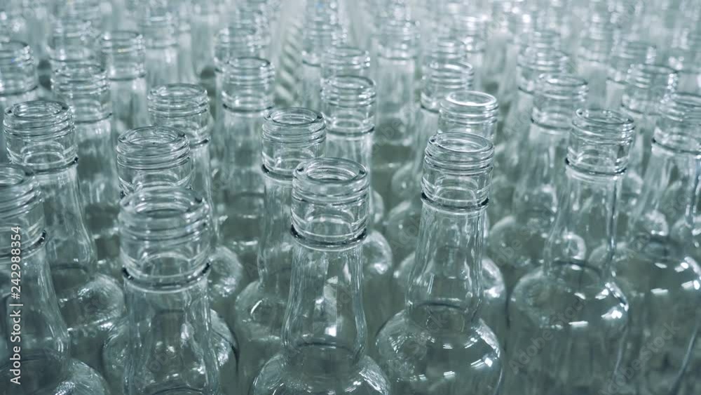 Plenty of empty glass bottles are moving slowly Plenty of empty glass bottles are moving slowly