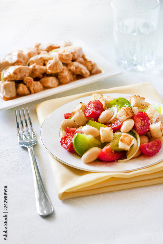 Salad with three kinds of tomatoes, boiled white kidney beans and croutons from white bread Salad with three kinds of tomatoes, boiled white kidney beans and croutons from white bread